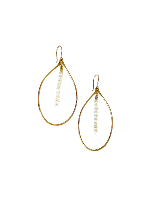Gold teardrop earrings with pearl-like beads on a white background