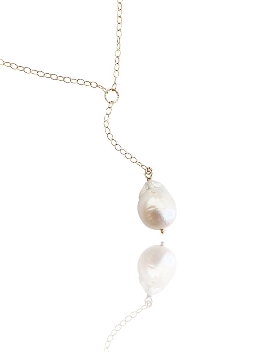 Pearl necklace with gold chain on a white background